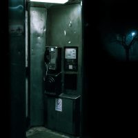 green and black telephone booth