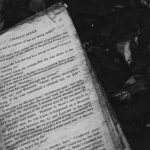 grayscale photo of book on ground