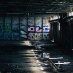 a dark room with graffiti all over the walls