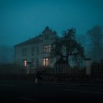 person walking towards house