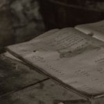 A pile of vintage open books on a rustic wooden table in a cozy indoor setting.