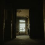 Explore the eerie interior of an abandoned building, capturing its desolate charm.