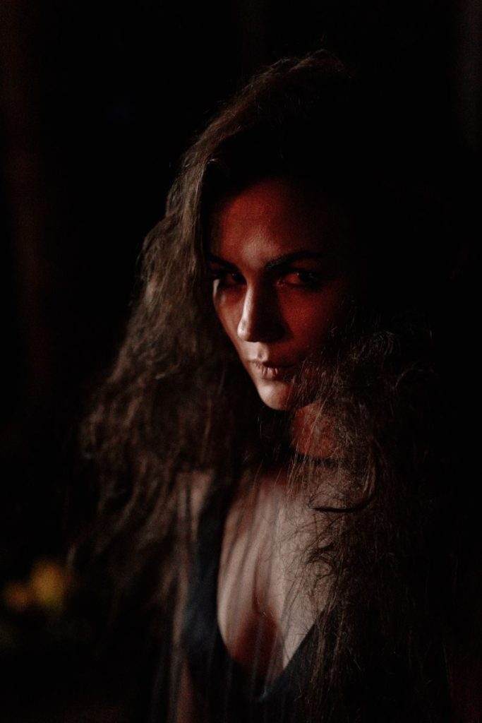 Dark portrait of a woman with mystic and gothic elements, evoking a serious mood.