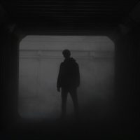silhouette of man standing in front of window